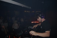 a man djing in front of a crowd of people